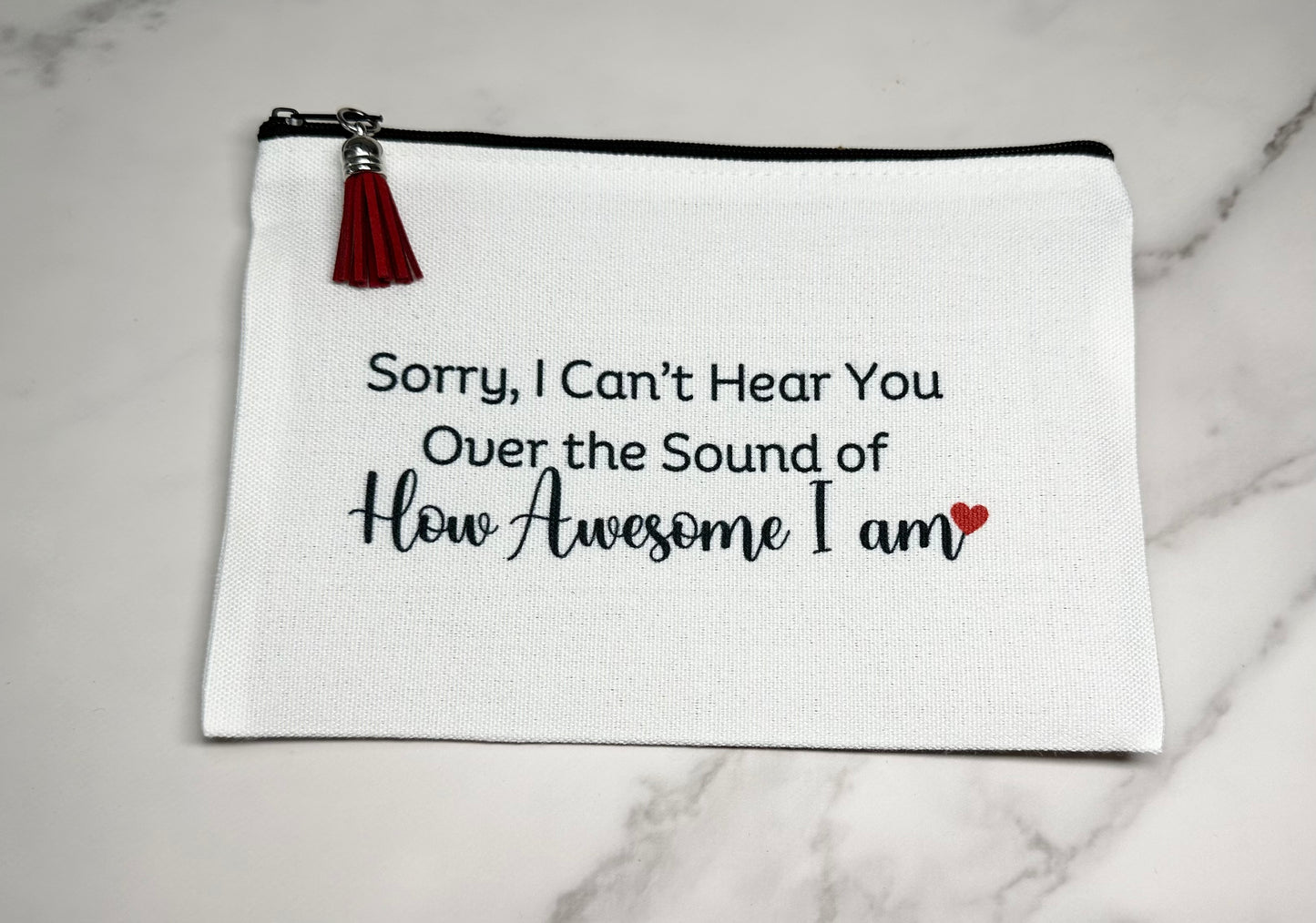 White pouch with black text 'Sorry, I can't hear you"