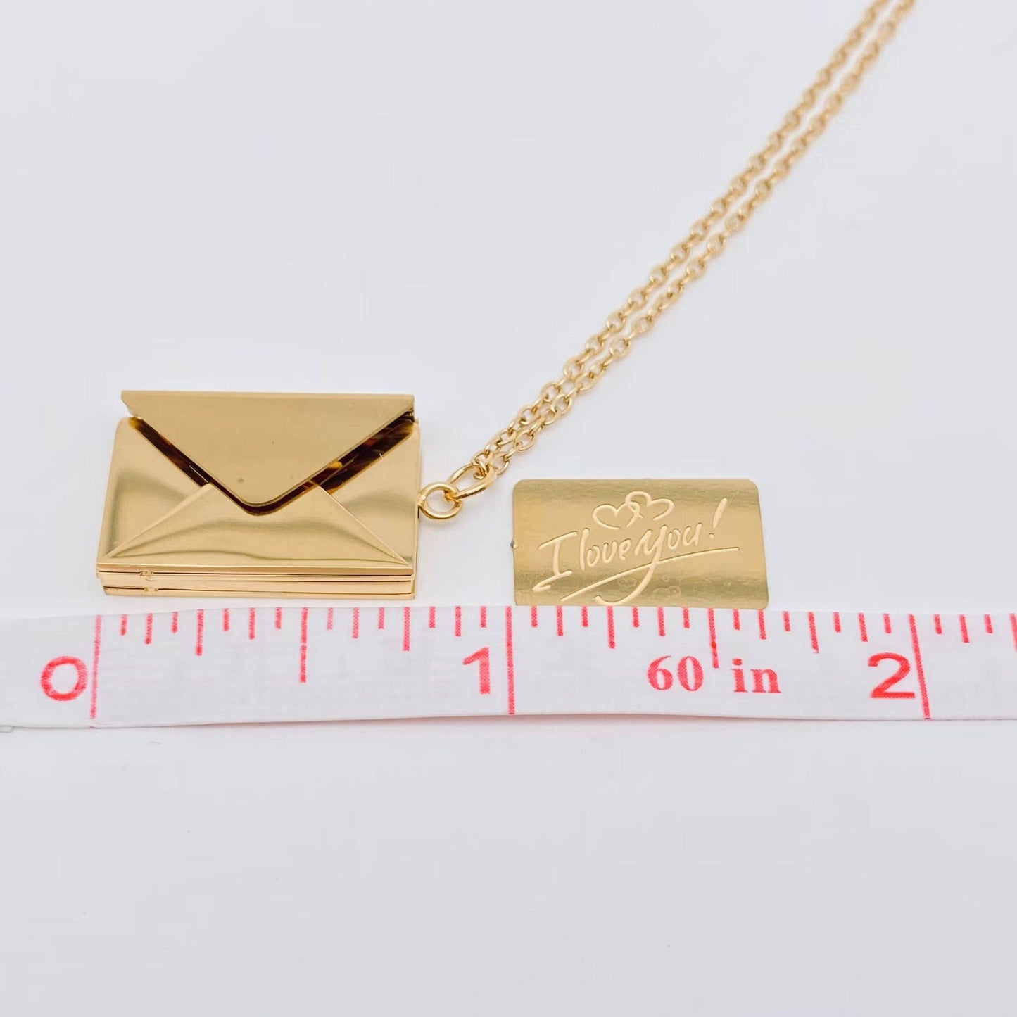 Gold necklace with an envelope pendant with engraved 'I love you' tag that goes in envelope showing measurements