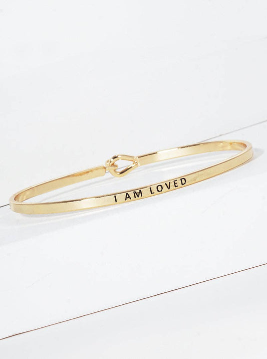 Gold bracelet engraved with 'I AM LOVED'