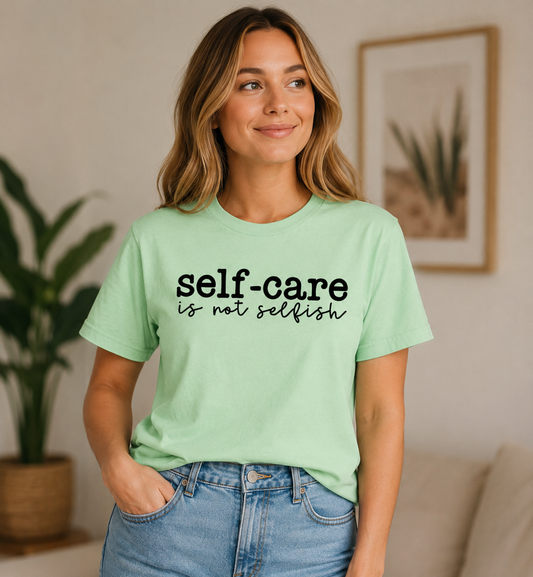 light green t-shirt with 'self-care is not selfish' text in black