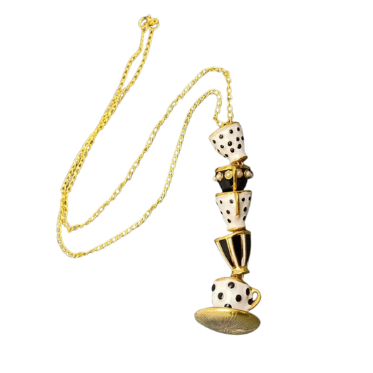Necklace with a unique design featuring tea cups with gold accents on a gold chain
