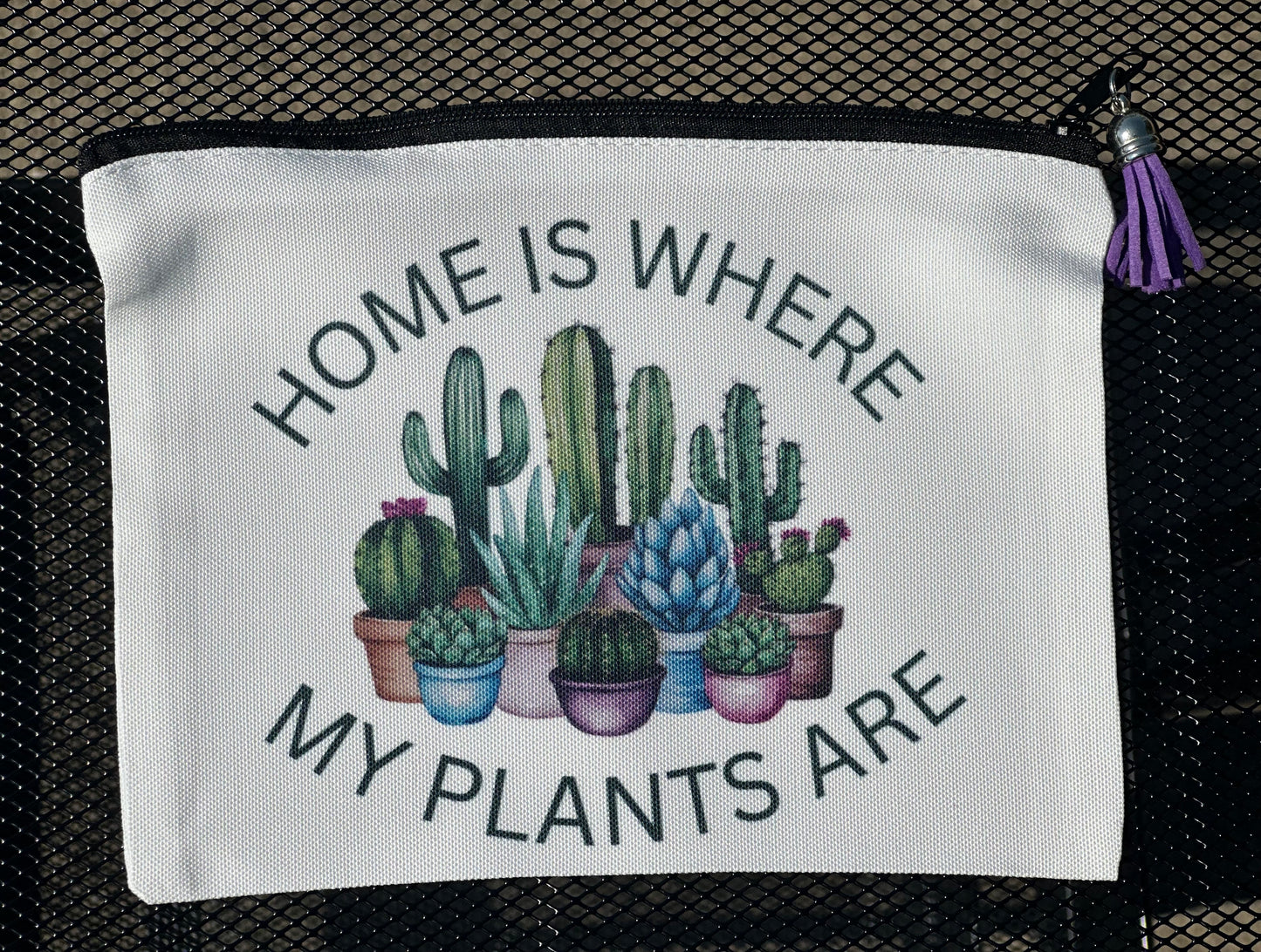 White pouch with cactus illustration and text 'Home is where my plants are' 
