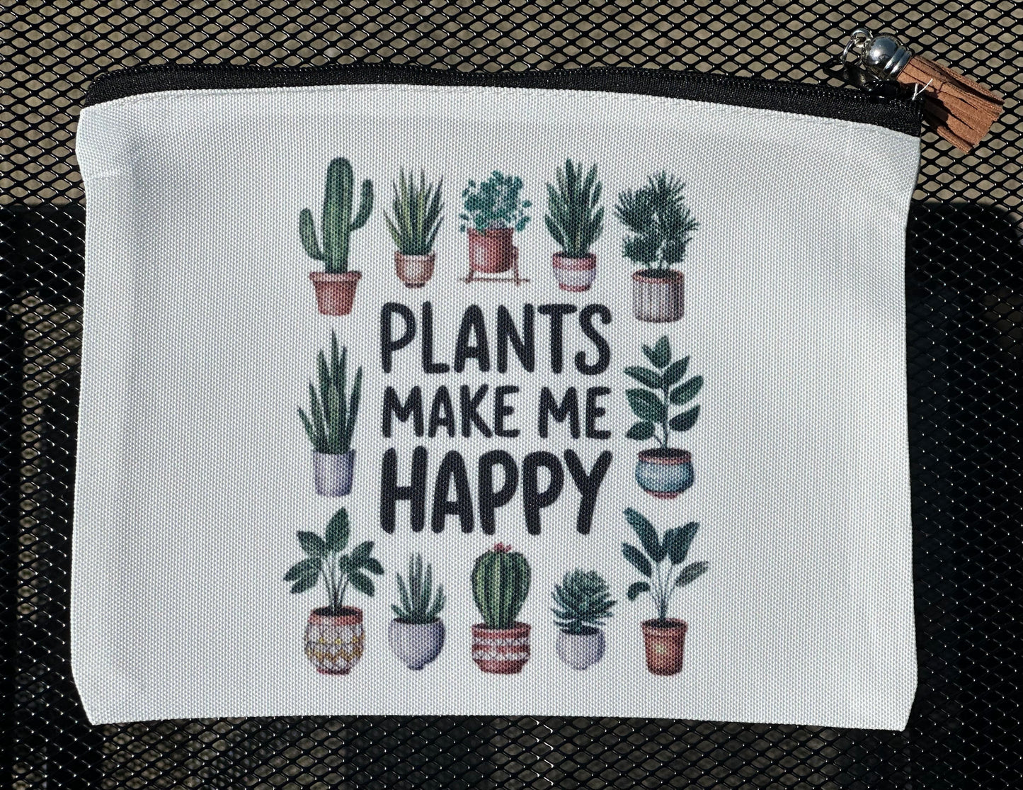 White pouch with plant illustrations and 'Plants Make Me Happy' text 