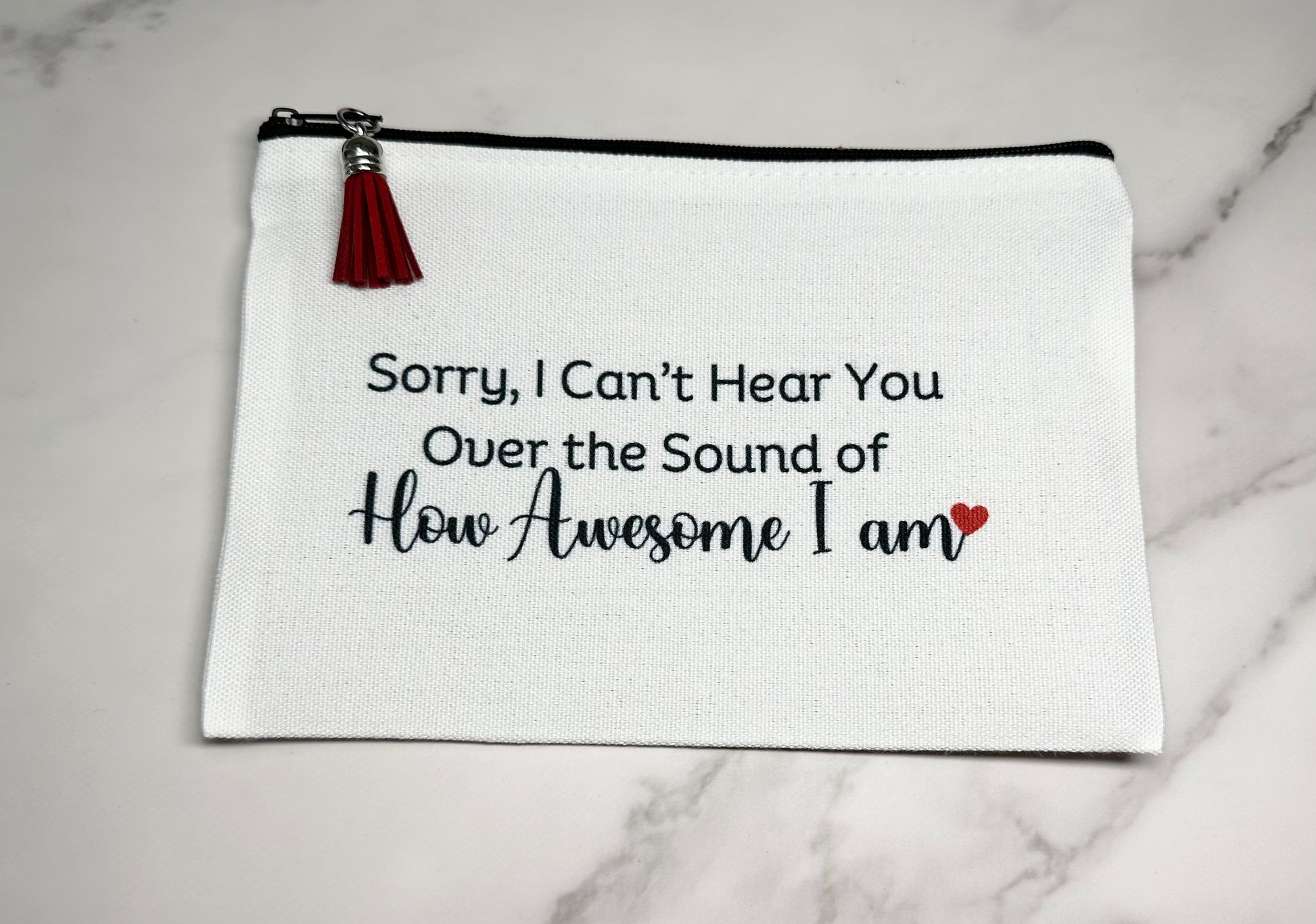 White pouch with black text 'Sorry, I can't hear you"
