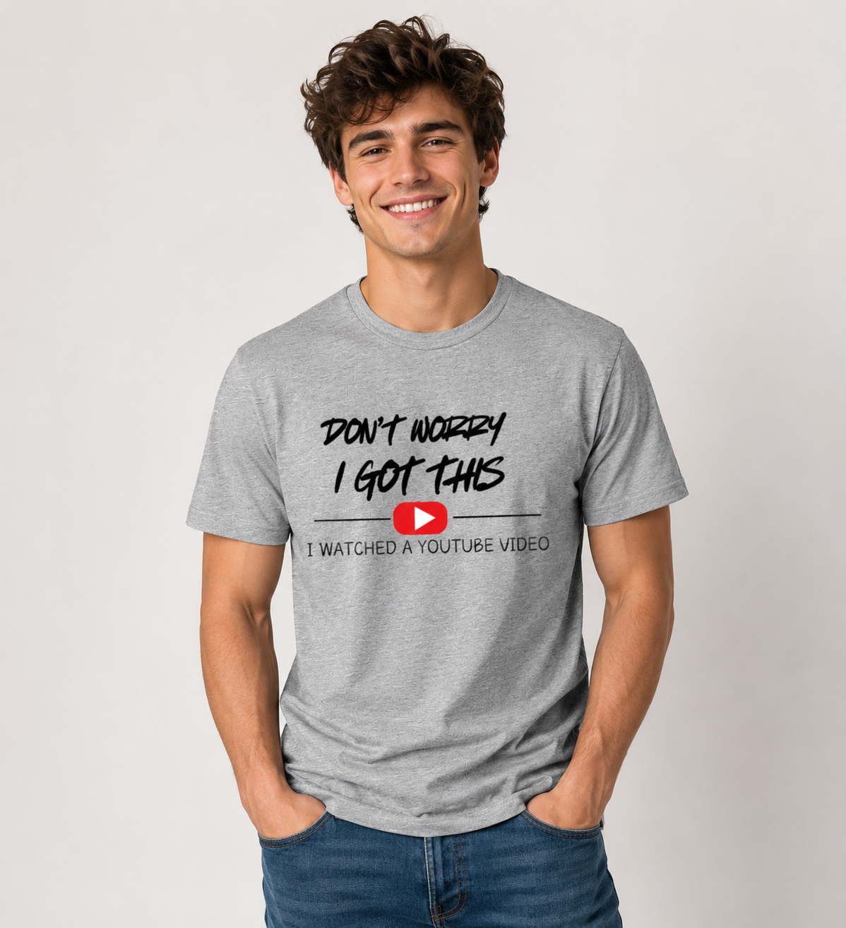  A man wearing a gray t-shirt with a humorous text design Don't Worry I Got This I watched a Youtube Video