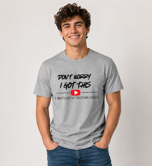  A man wearing a gray t-shirt with a humorous text design Don't Worry I Got This I watched a Youtube Video