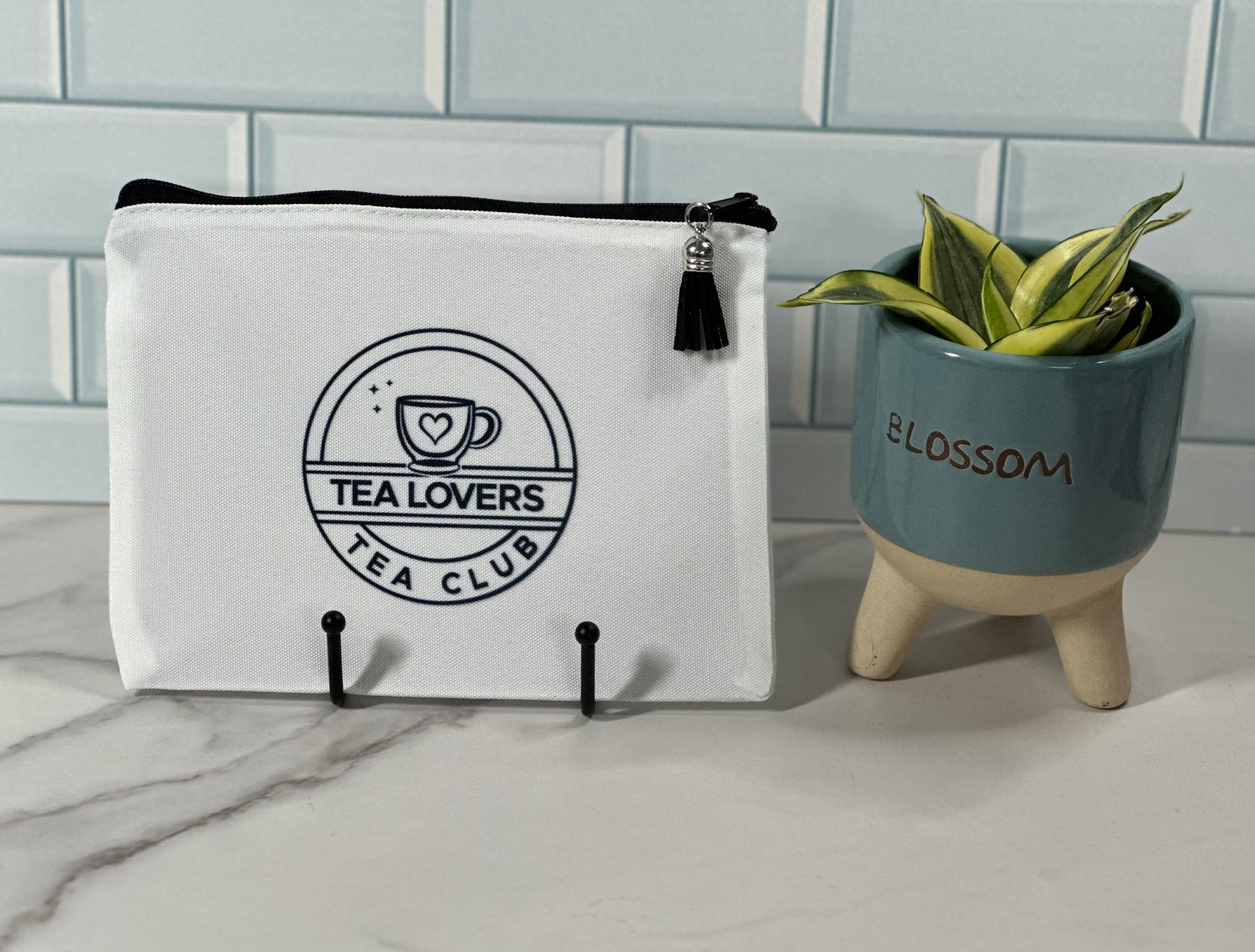 White pouch with 'Tea Lovers Tea Club' logo 