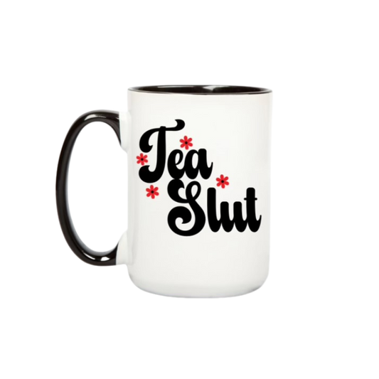 White mug with black text 'Tea Slut' and red flowers on a white background